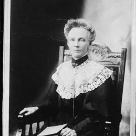 Studio portrait of an unidentified seated woman wearing a lace collar.