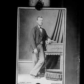 Portrait of an unidentified man wearing check trousers.