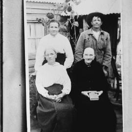 An unidentified group of three women and a man.