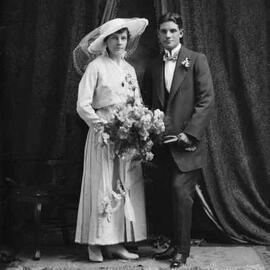 Studio portrait of a bride and groom.  Family name Warne.