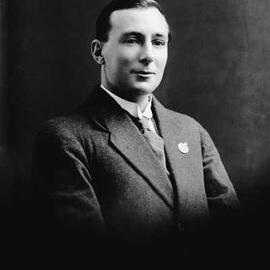 Portrait of a man wearing an A.I.F. badge.