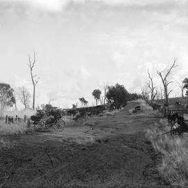 Jinkers parked along a track in  farmland,  possibly near Benalla.