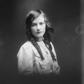 Studio portrait of an unidentified girl with long hair.