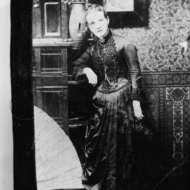 Portrait of an unidentified woman wearing an elaborate black dress.