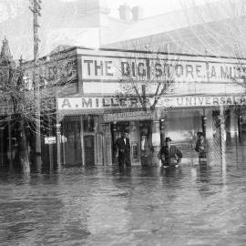 Men standing in floodwaters in central Benalla.
