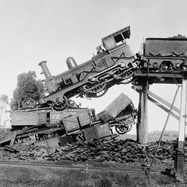 A train crash in Seymour showing a locomotive suspended off the edge of an overhead rail track.