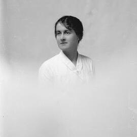 Portrait of an unidentified young woman wearing a white blouse.