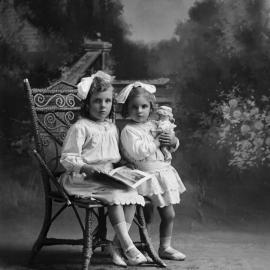 Studio portrait of  two girls.  Family name possibly Ridgewell.