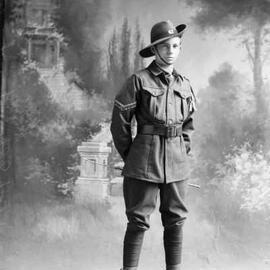 Studio portrait of a young man in an army style uniform.  Family name Fordham.