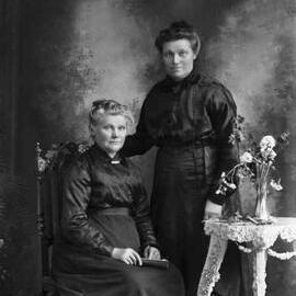 Studio portrait of two woman.  Family names Kirby and Horrigan.
