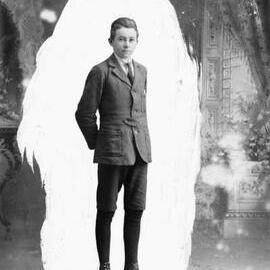 Portrait of a young man in jacket, short pants and tie. Family name Young.