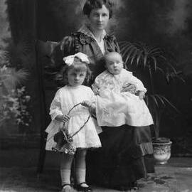 Studio portrait of Mrs. Smith with two children.
