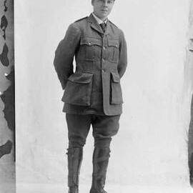 Studio portrait of Miss Cameron in an army style uniform and a YMCA cap.