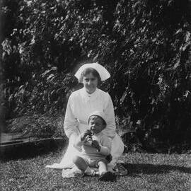 An unidentified woman holding a young boy.