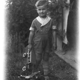An unidentified young boy with toys.