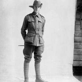 Studio portrait of a young man in an army style uniform.  Family name possibly Catheray.