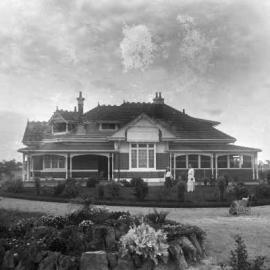 A large brick Edwardian single story home and garden.