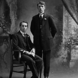 Studio portrait of two well dressed young men.  Family name Shiels.