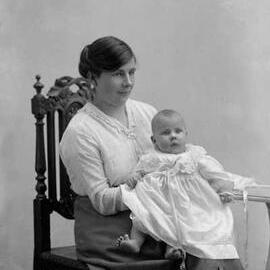 Studio portrait of a seated woman holding a baby.  Family name Pierce.
