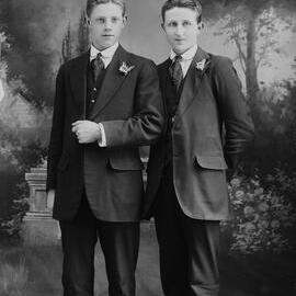 Studio full-length portraits of two young men.