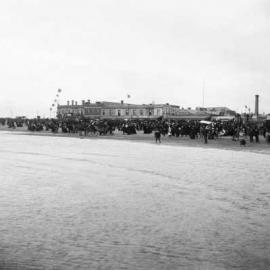 Port Melbourne beachfront scene showing festivities and buildings in the background.