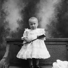 Studio portrait of a young girl with short hair.  Family name Archer.