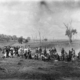 An unidentified group of people relaxing in a farmland environment.