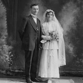 Studio portrait of Mr. & Mrs. Morris in wedding attire.