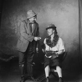 Two unidentified people in costume in a studio.