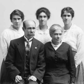 A seated man and woman with three younger women standing behind.  Family name Casson.
