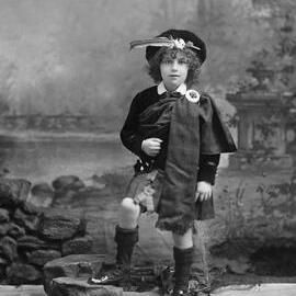 Studio portrait of a child in a Scottish costume.