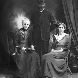 Studio portrait of a group of two women and a uniformed man. Client's name Morgan.