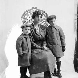 Portrait of a seated woman with two young boys.  Family name Jordan.
