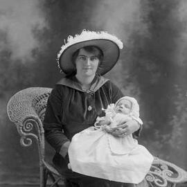 Studio portrait of  Mrs. Wilson holding a baby.