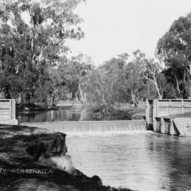 A weir with timber abutments on the Broken River at Benalla.