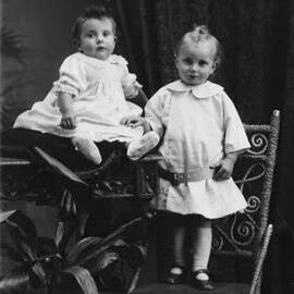 Studio portrait of  a young girl and a baby.  Family name Reeves.