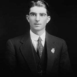 Studio portrait of a young man in a three-piece suit.