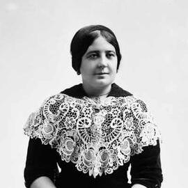 Portrait of Miss Ross wearing a dark dress and large lace collar.