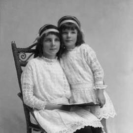 Portrait of two girls in similar dresses.  Family name Connellan.