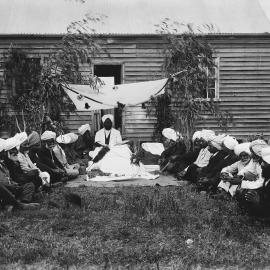 A group of Indian men, possibly Sikhs, outside a timber cottage at Reef Hills near Benalla.