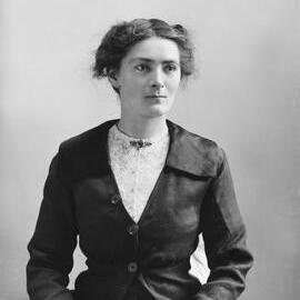 Studio portrait of  a young woman wearing a suit.