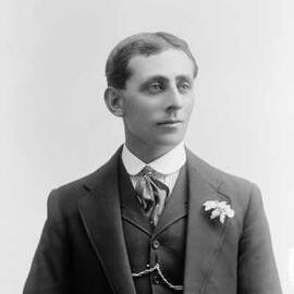 Portrait of a young man wearing a suit.  Family name Pearce.