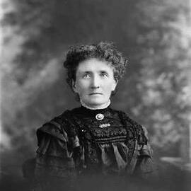 Studio portrait of Mrs. Hopkins wearing a black dress.