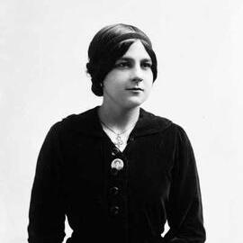 Portrait of Miss F. Ross wearing a dark dress.
