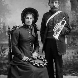 Studio portrait of a woman and man in Salvation Army uniforms.   Family name Leonard.