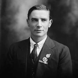 Studio portrait of Mr. Harris wearing armed services medals.