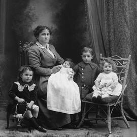 Studio portrait of a woman with four young children.