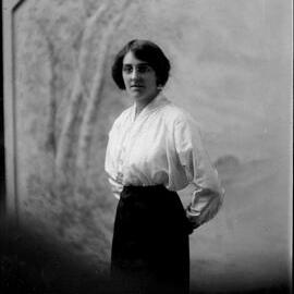 Indoor portrait of a standing woman.  Family name possibly Wallace.