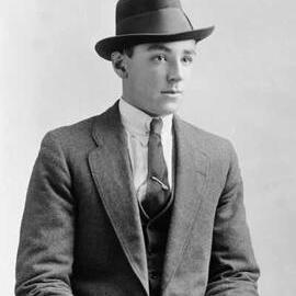 Studio portrait of a young man wearing a trilby hat.  Family name White.
