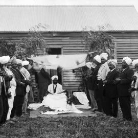 A group of Indian men, possibly Sikhs, outside a timber cottage at Reef Hills near Benalla.
